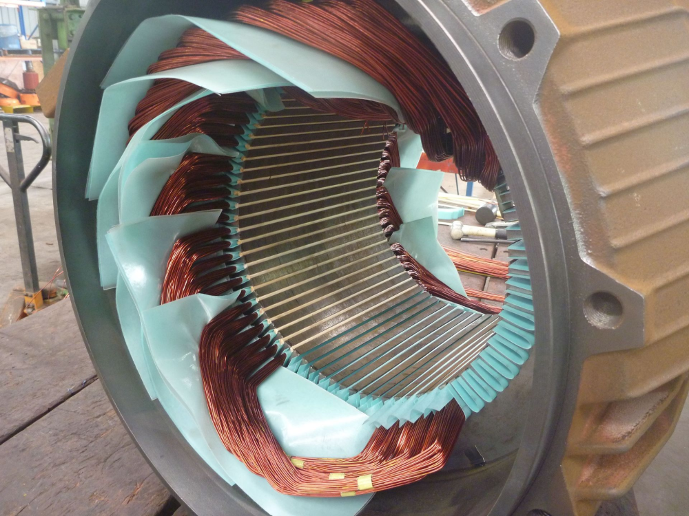 Copper windings inside a motor housing, with protective blue insulation. — Davidson's Electrical In Mackay, QLD