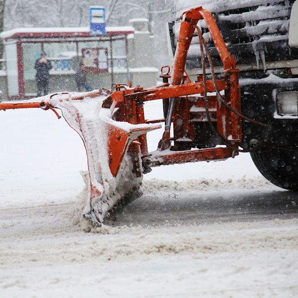 snow plow working to remove snow on street