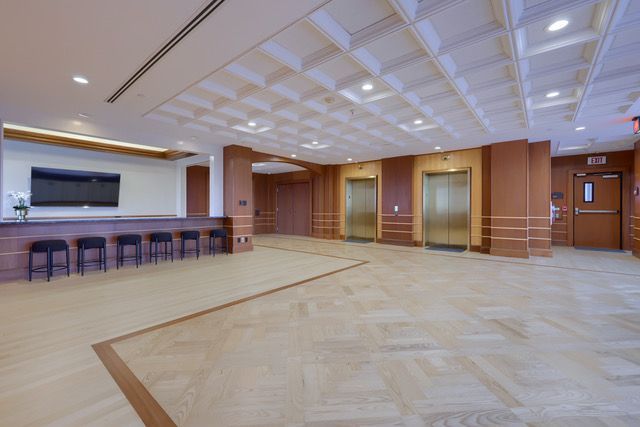There are two elevators in the lobby of a building.