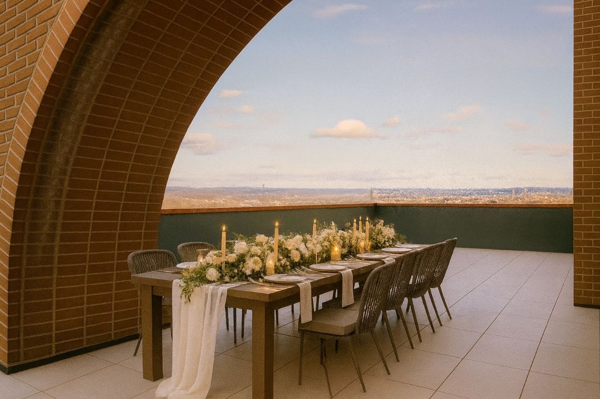 A brick building with a patio with a table and chairs on it.