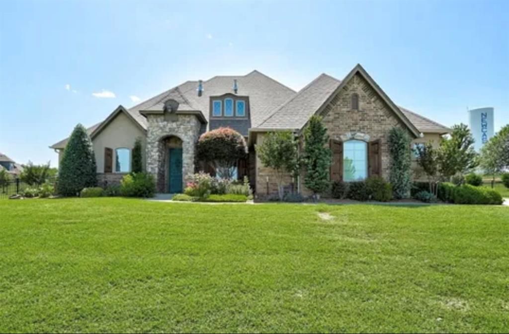 A large house with a large lawn in front of it