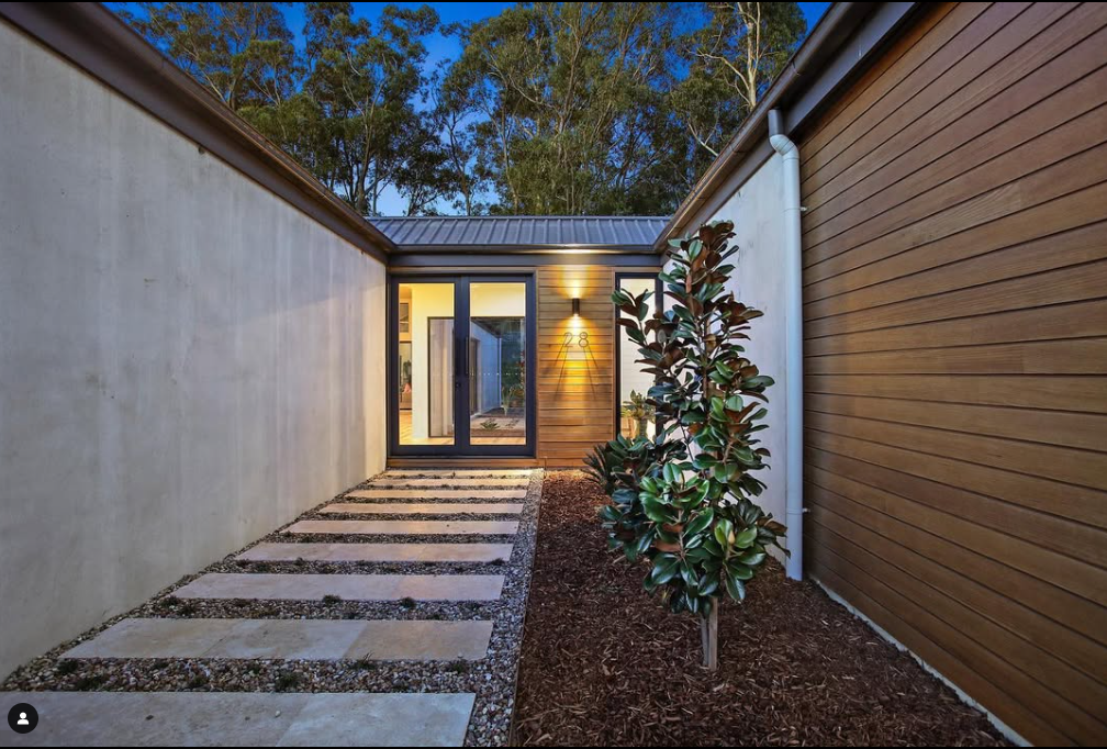 A house with a walkway leading to it.