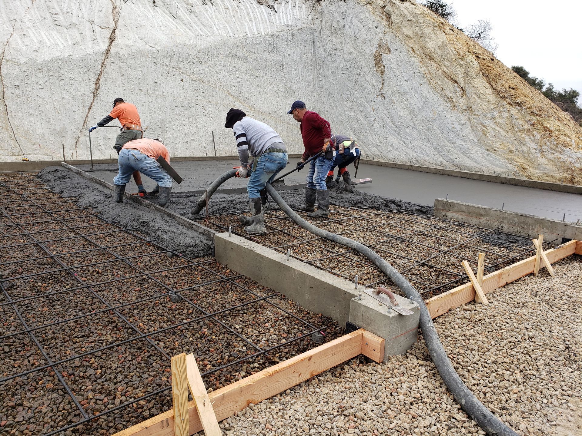 A group of construction workers are working on a road.
