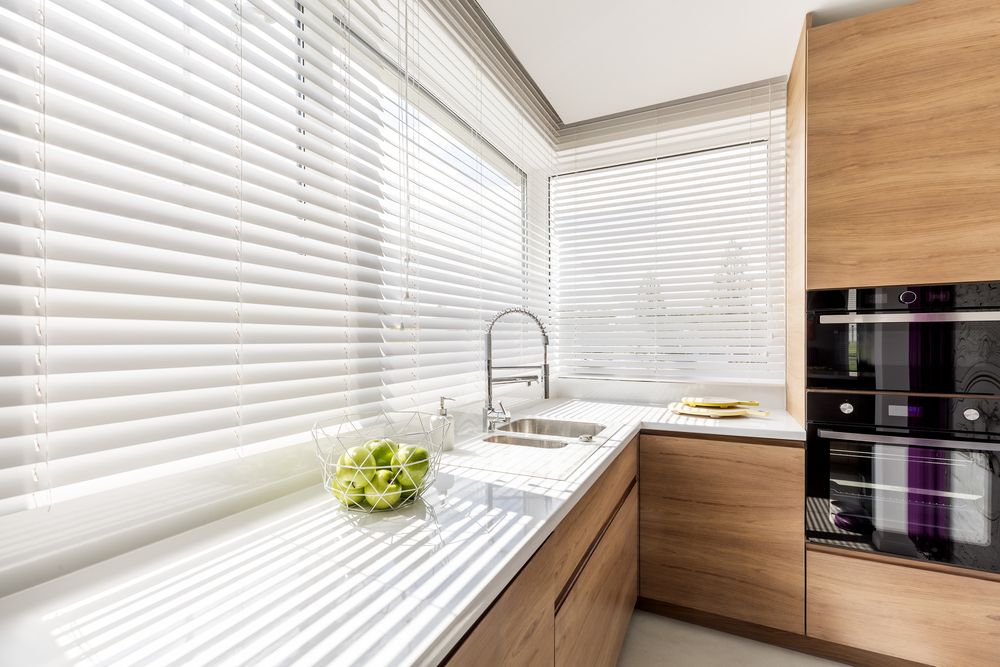 A Kitchen With Wooden Cabinets, a Sink, and a Window With Blinds — Lismore Blinds in Alstonville, NSW