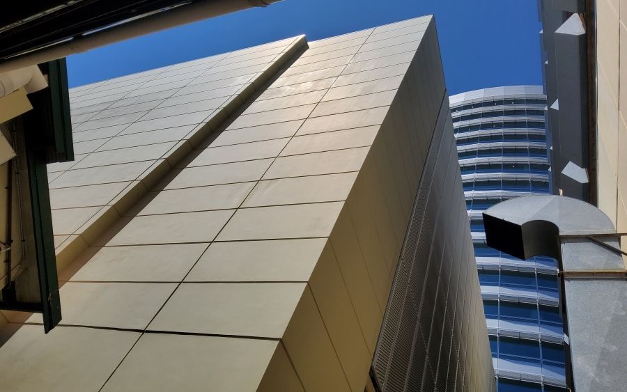 Angular Gold-Toned Building Against a Bright Blue Sky — EXPOSURE NORTH PLASTERING PTY LTD in Berry Springs, NT