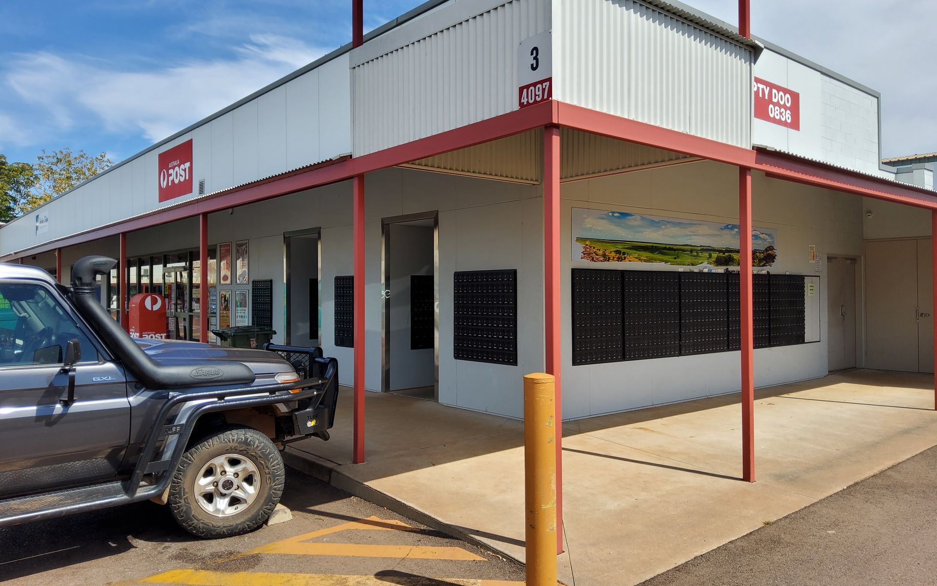 Grey Building With Red Awning, Post Office Boxes, a 4x4 Vehicle, and a Sign That Reads Post Office — EXPOSURE NORTH PLASTERING PTY LTD in Berry Springs, NT