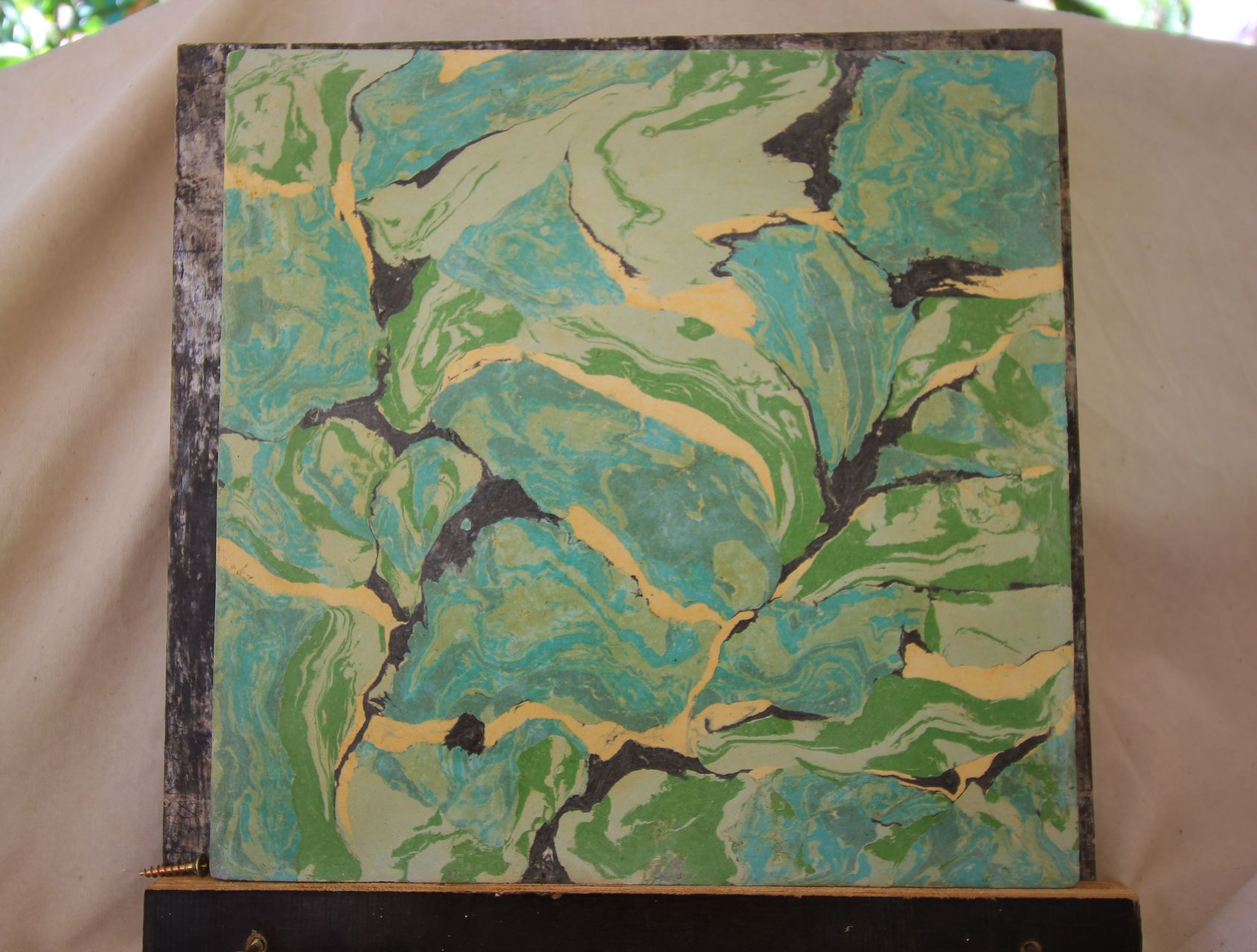Abstract Marbled Painting in Shades of Green Framed in Aged Metal — EXPOSURE NORTH PLASTERING PTY LTD in Berry Springs, NT