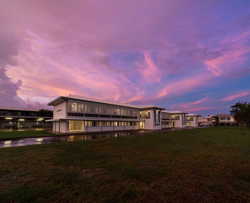 School Building at Sunset, With a Vibrant Pink and Purple Sky — EXPOSURE NORTH PLASTERING PTY LTD in Berry Springs, NT