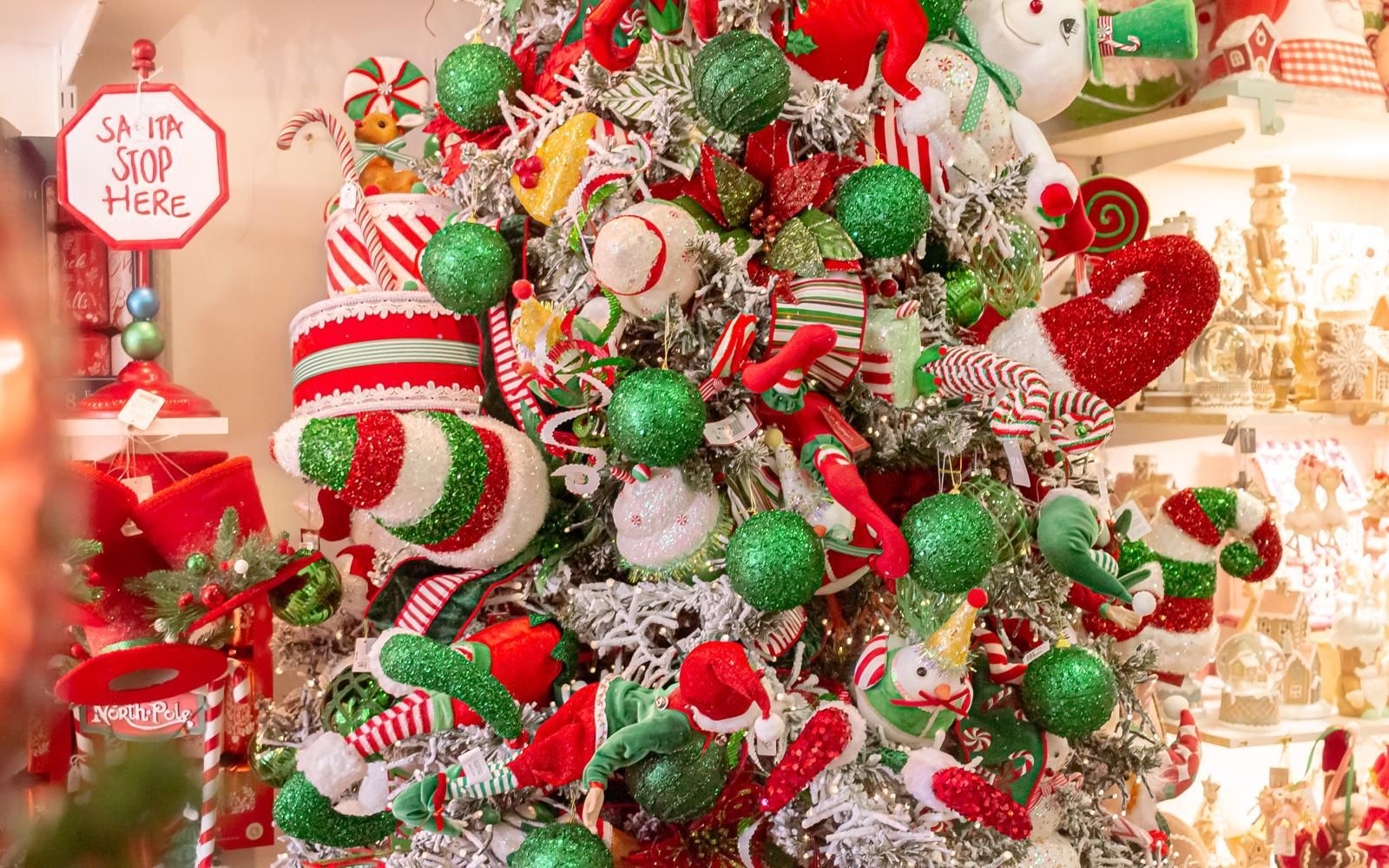 A close up of a christmas tree decorated in red , green and white.