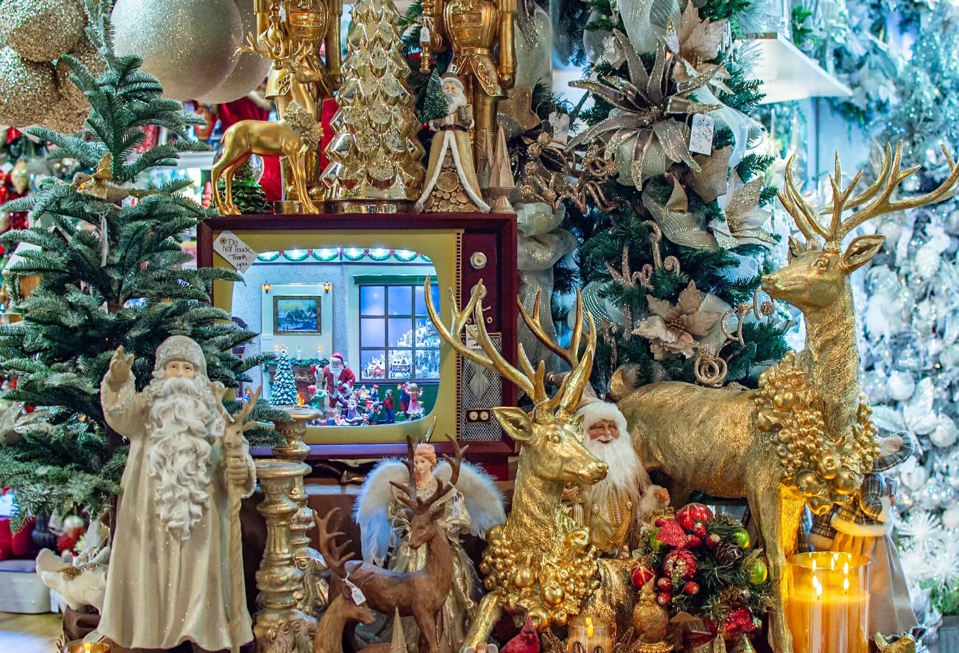 A display of christmas decorations including santa claus , reindeer , and a christmas tree.