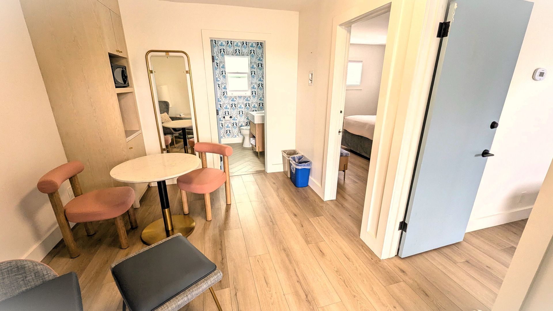 Room with three doors open into other rooms.