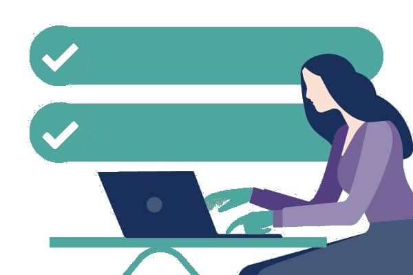 A woman is sitting at a table using a laptop computer.