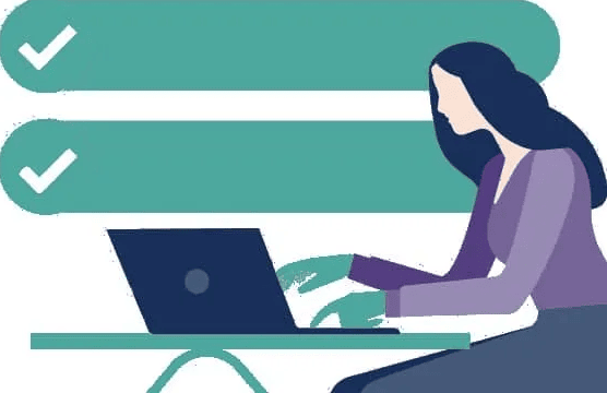 A woman is sitting at a table using a laptop computer.