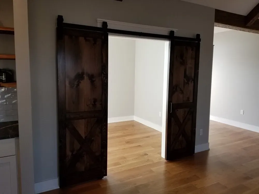 A pair of dark wood barn doors with an