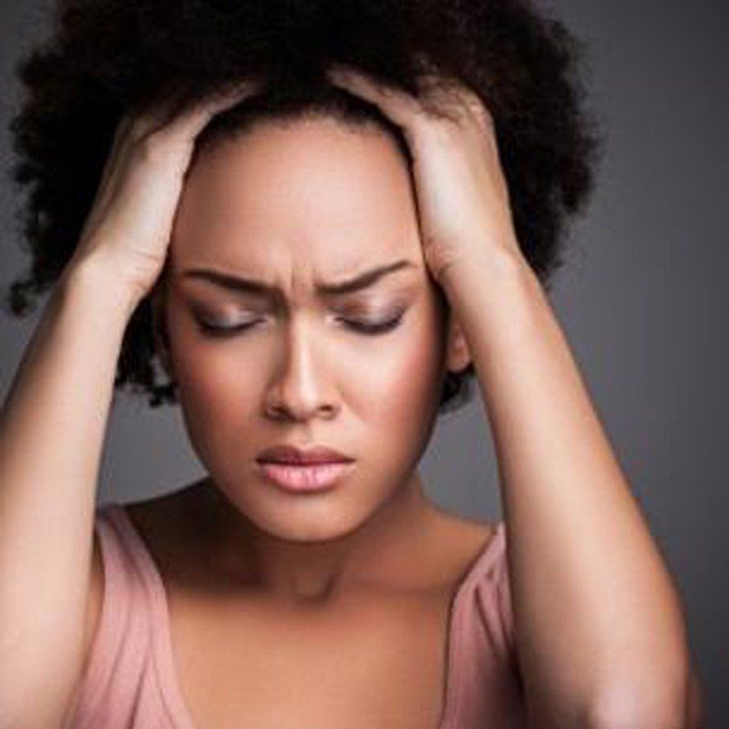 woman holding head