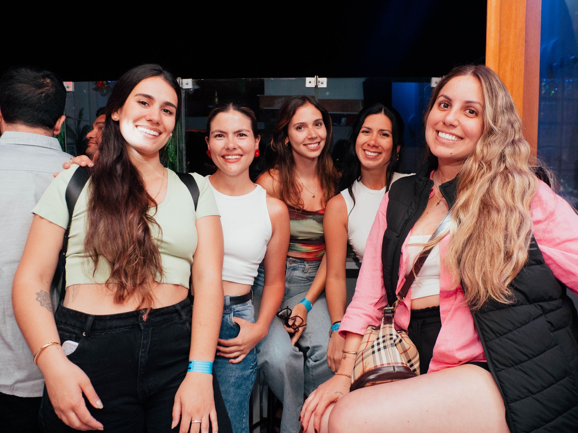 A group of young women are posing for a picture at a party.