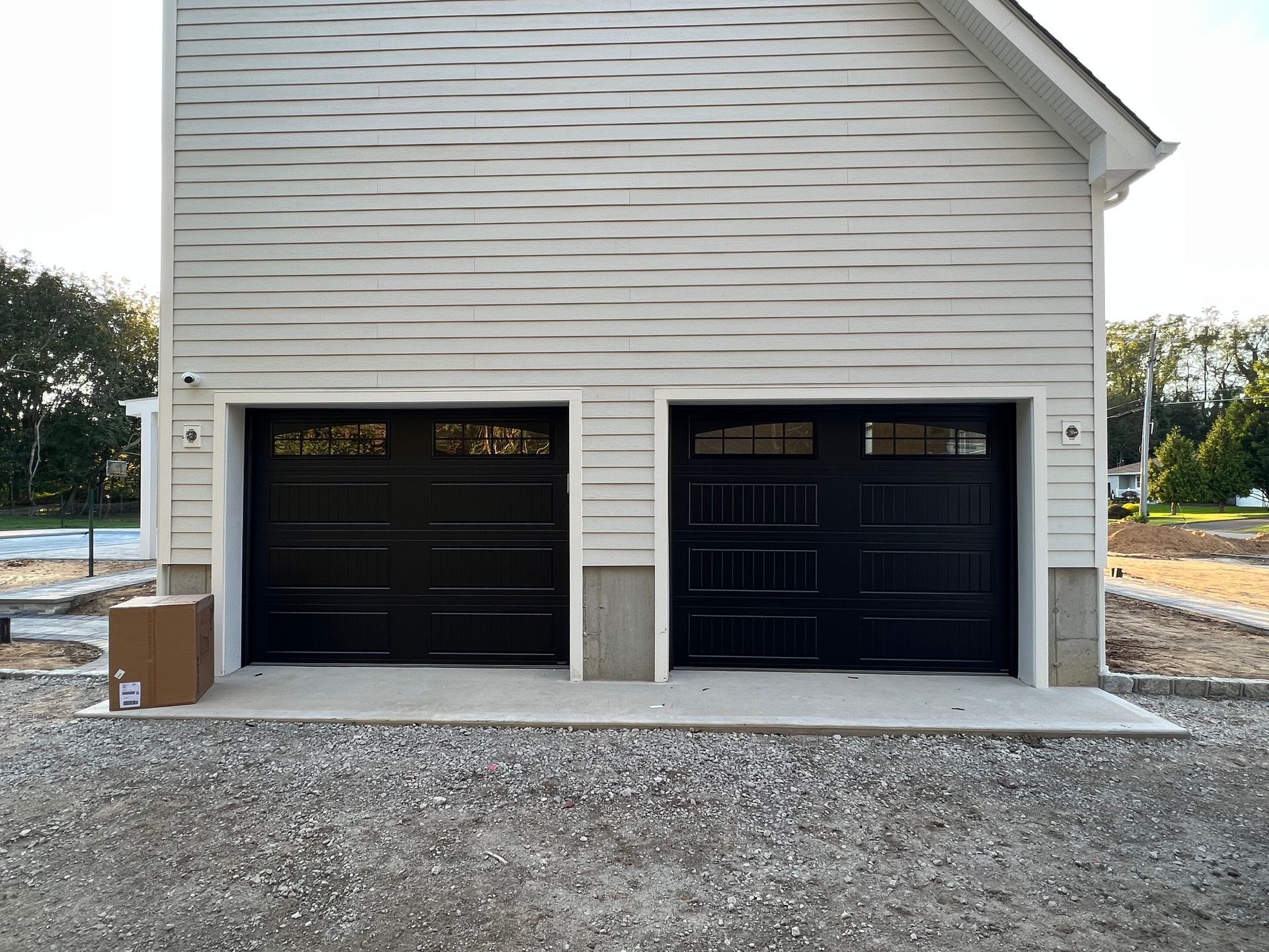 Garage door opener rail and motor mounted on a white wall near the ceiling