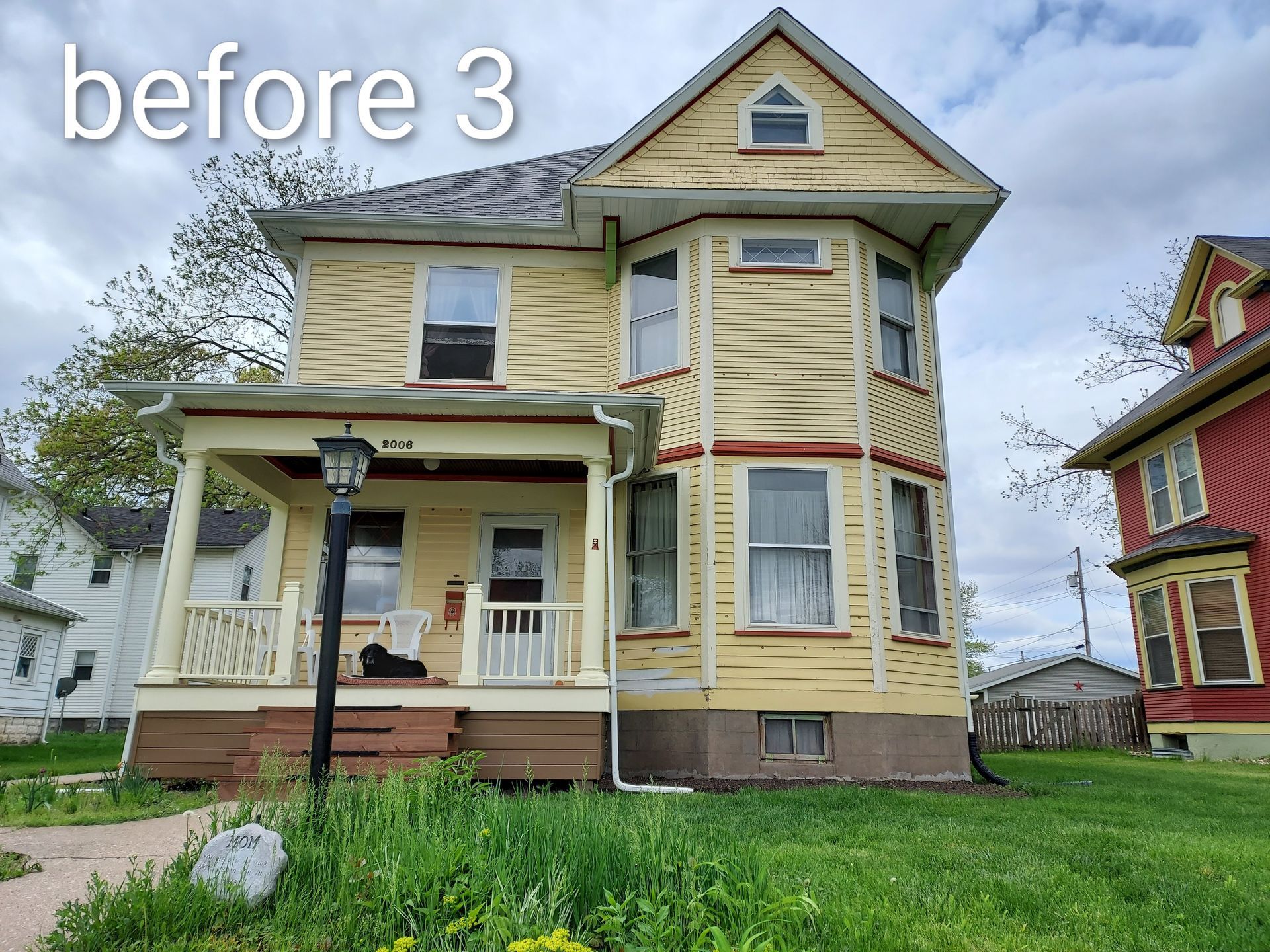 Front view of a weathered yellow Victorian house with porch and green lawn, labeled “before 3”
