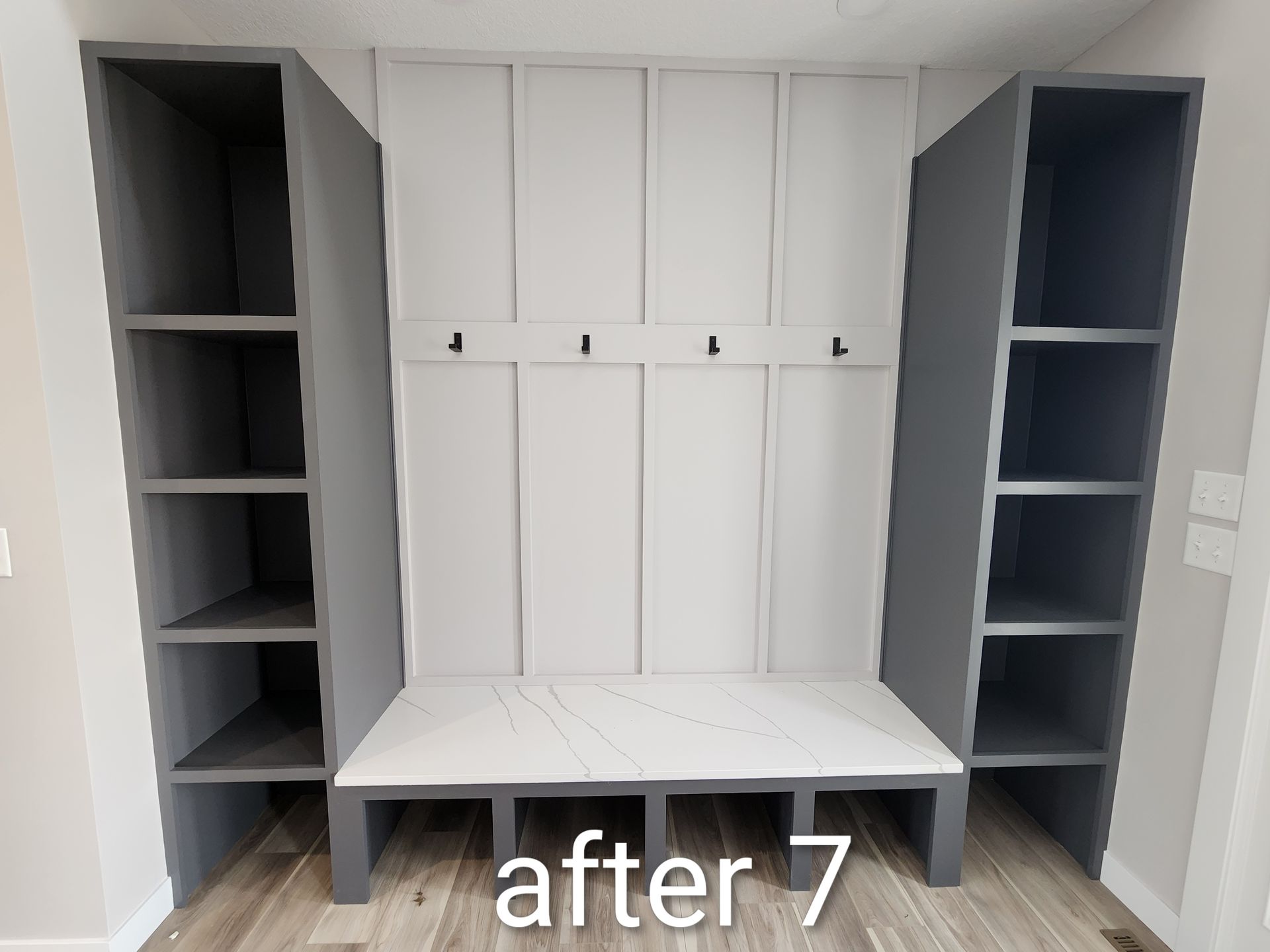 White built-in mudroom bench with cubbies and hooks between two gray storage towers, labeled “after 7.”