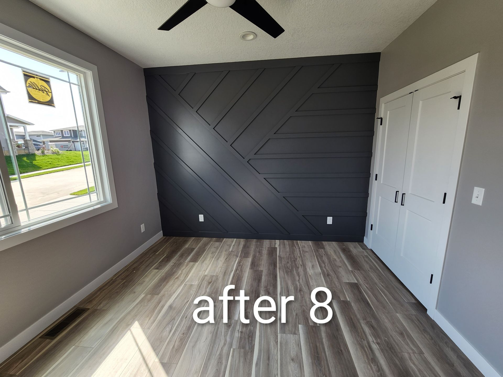 Empty gray bedroom with dark accent wall, white double doors, ceiling fan, and text “after 8.”