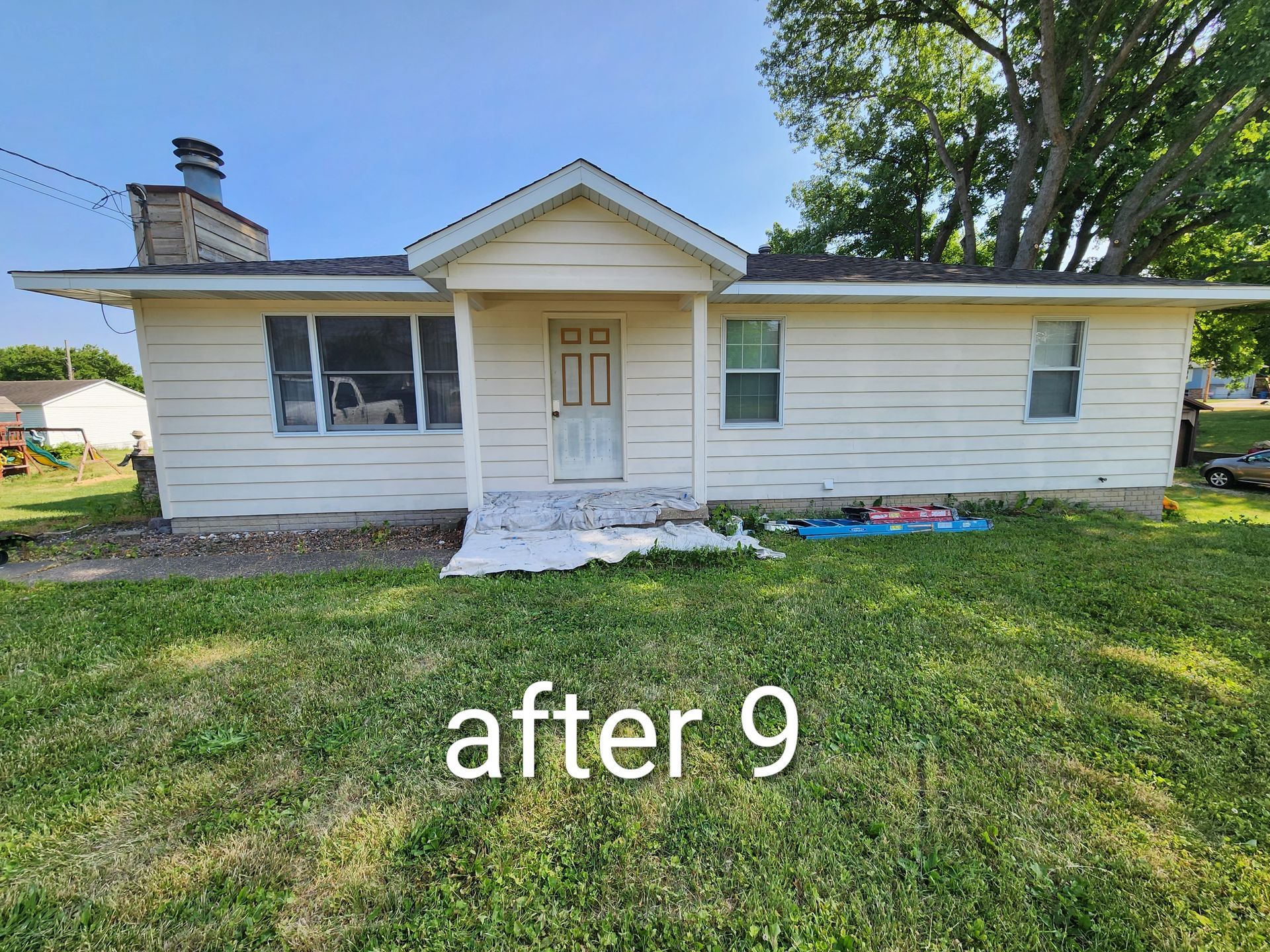 Front view of a white single-story house with a small porch and lawn, labeled “after 9”