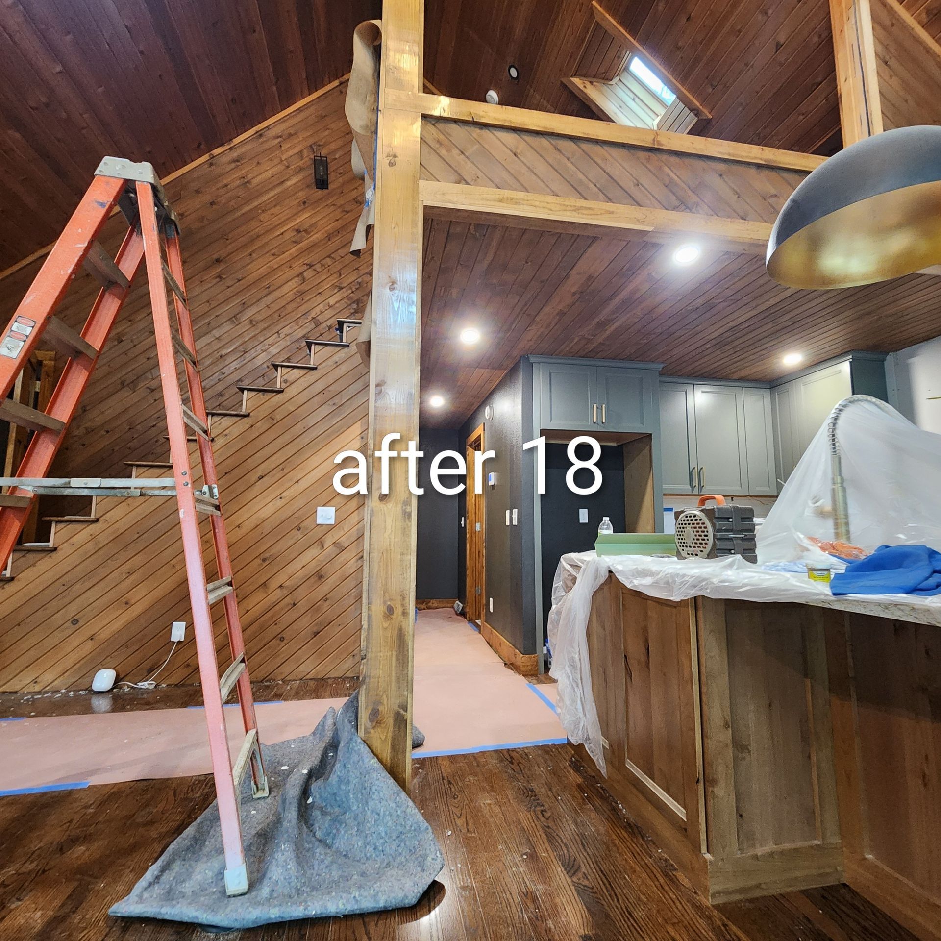 Wood-paneled loft interior with ladder, stairs, counter, and text “after 18” over the center