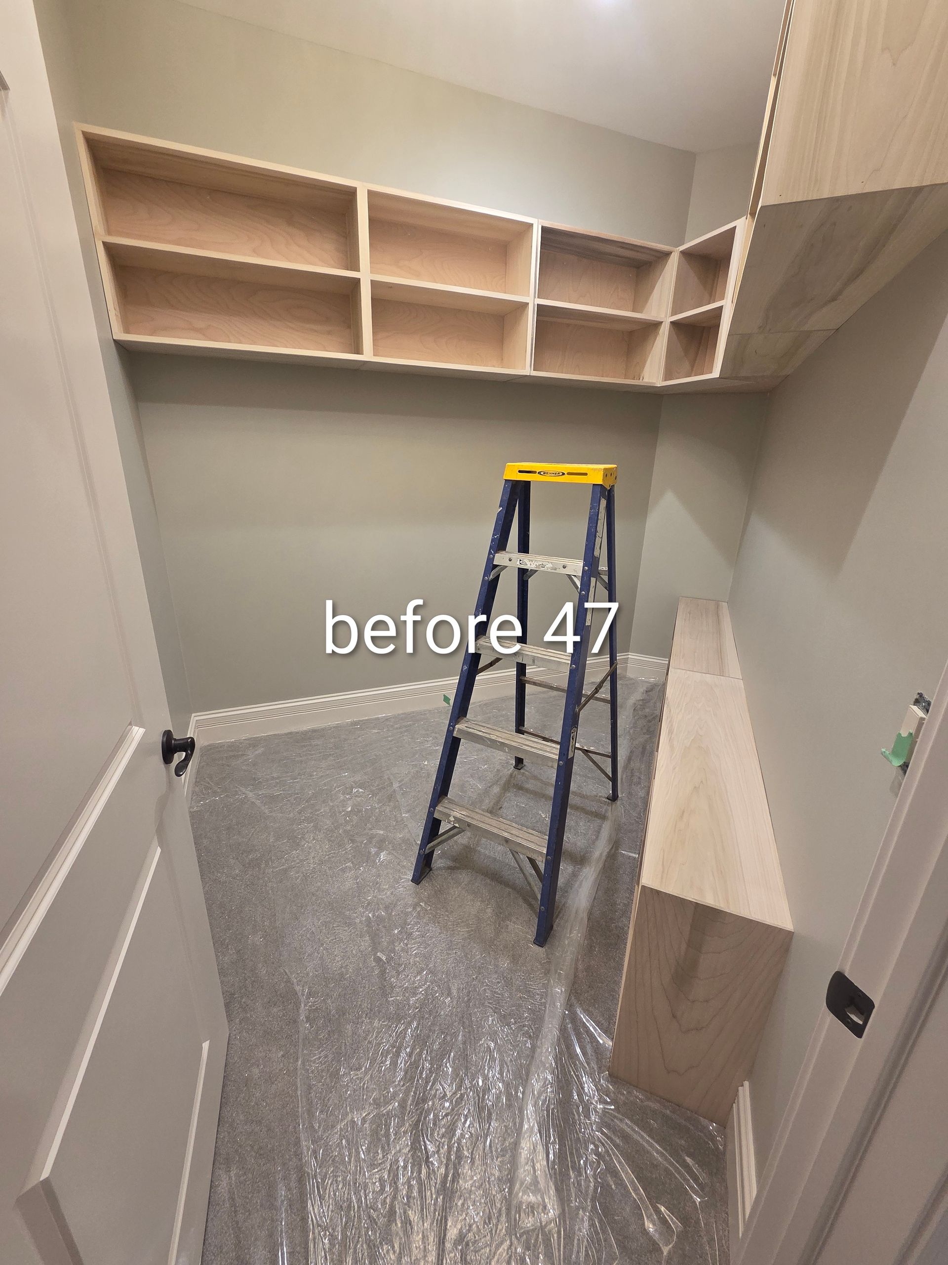 Small closet under renovation with open beige shelves, ladder, and floor covered in protective plastic.