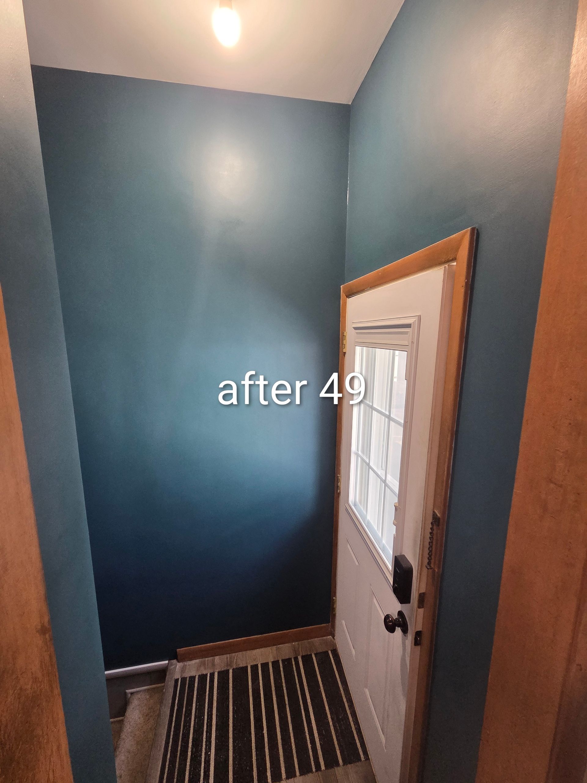 Narrow blue hallway with a white door, striped rug, and text reading “after 4.”