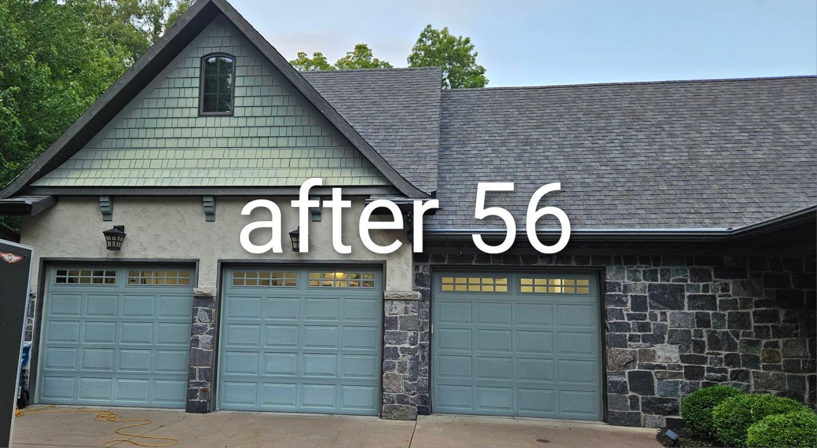 House exterior with three blue garage doors and a green gable, labeled “after 56”