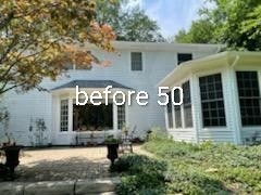 White house exterior with front patio and trees, overlaid text “before 50”