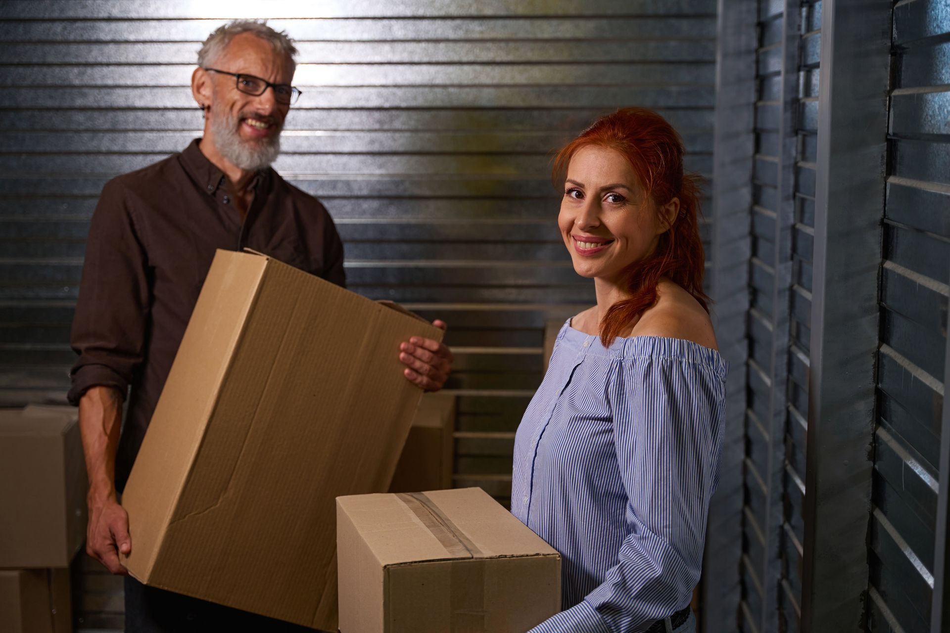 Couple carrying boxes inside self-storage facility in Palmer, Alaska