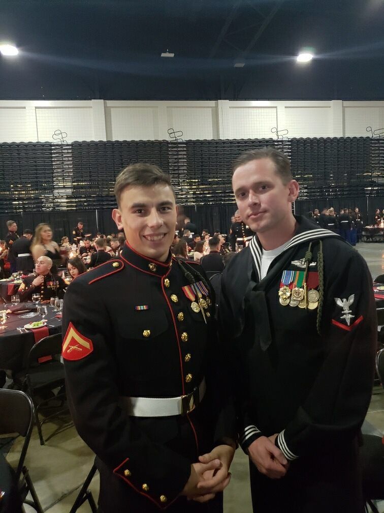 Two men in military uniforms are posing for a picture.