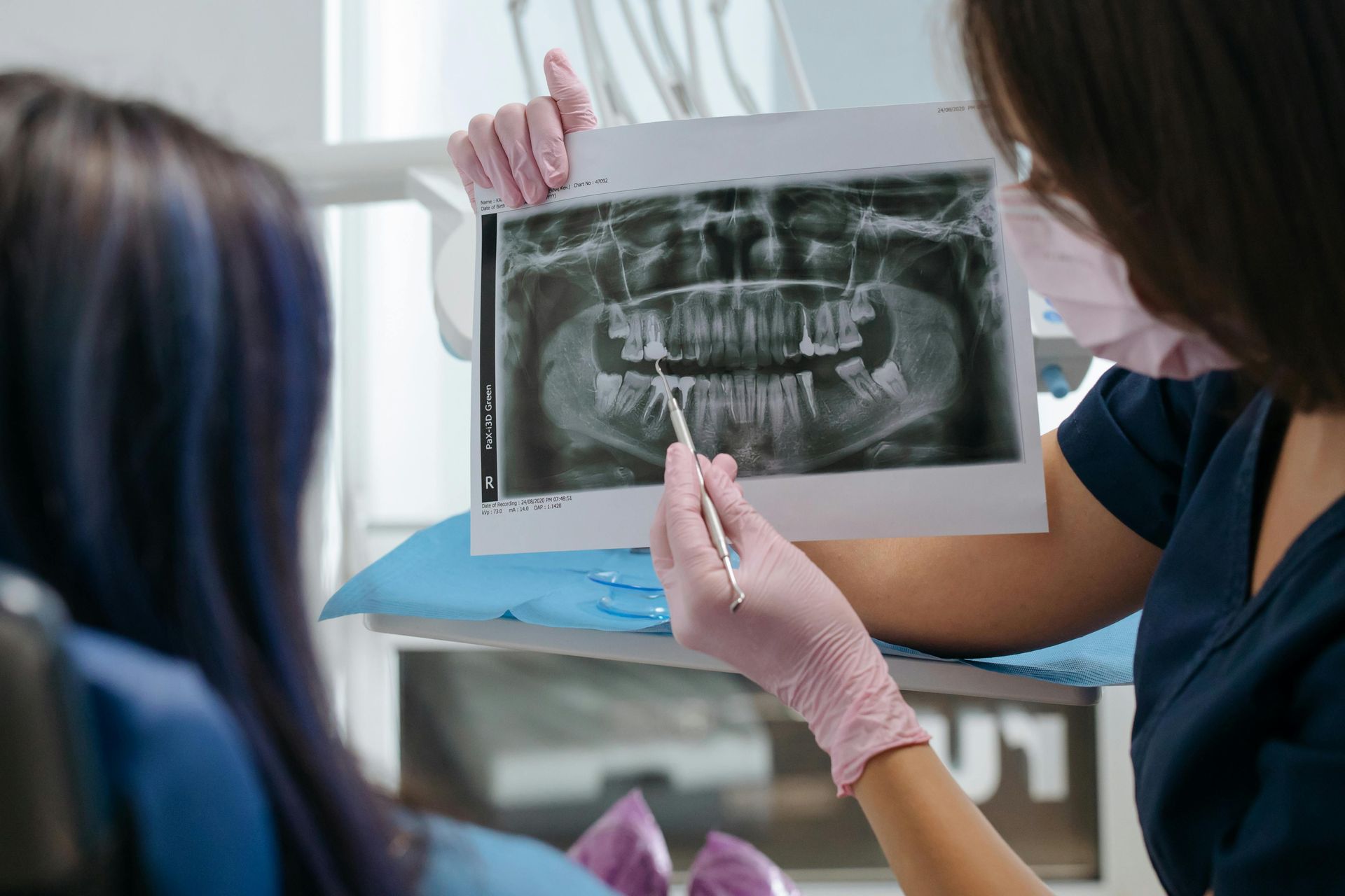Dental hygienist performing a professional dental cleaning for an adult patient in Babylon NY
