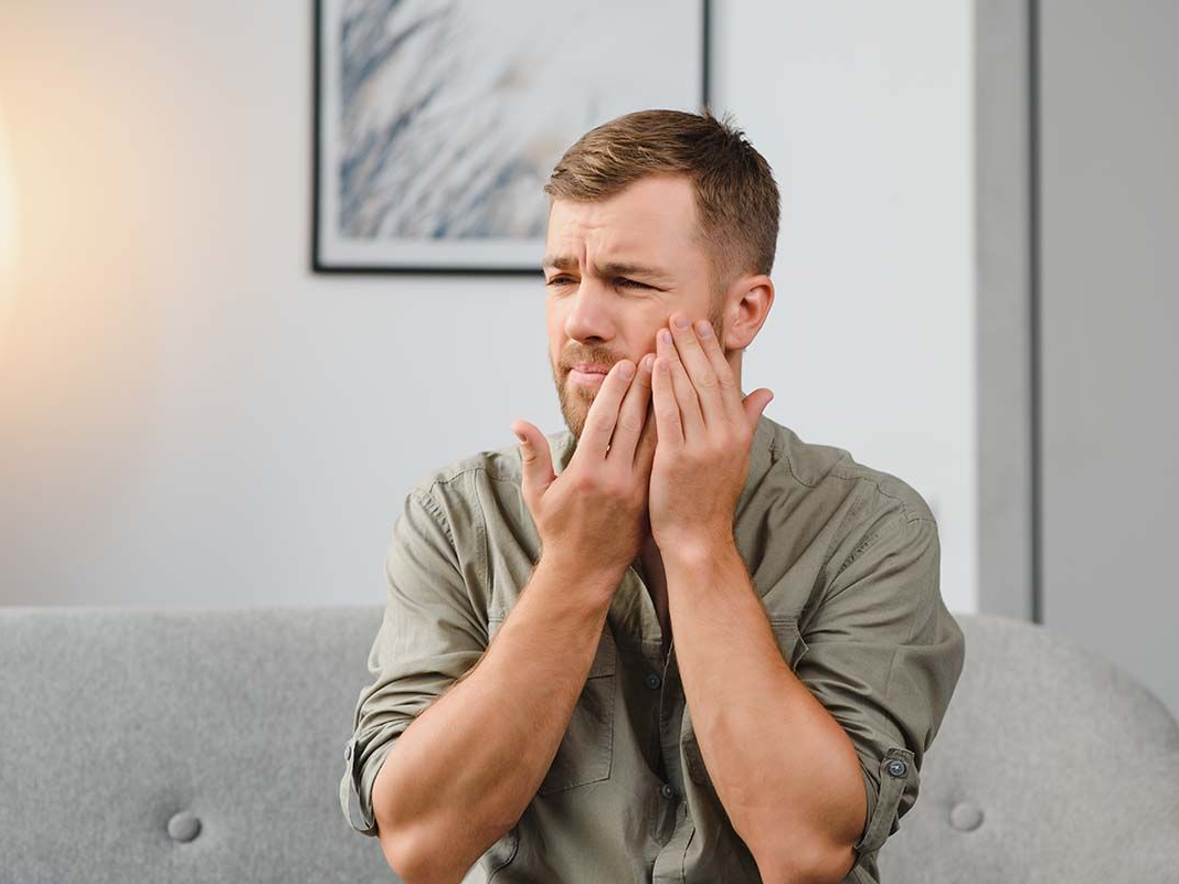 Man with toothache needing to visit the dentist. 