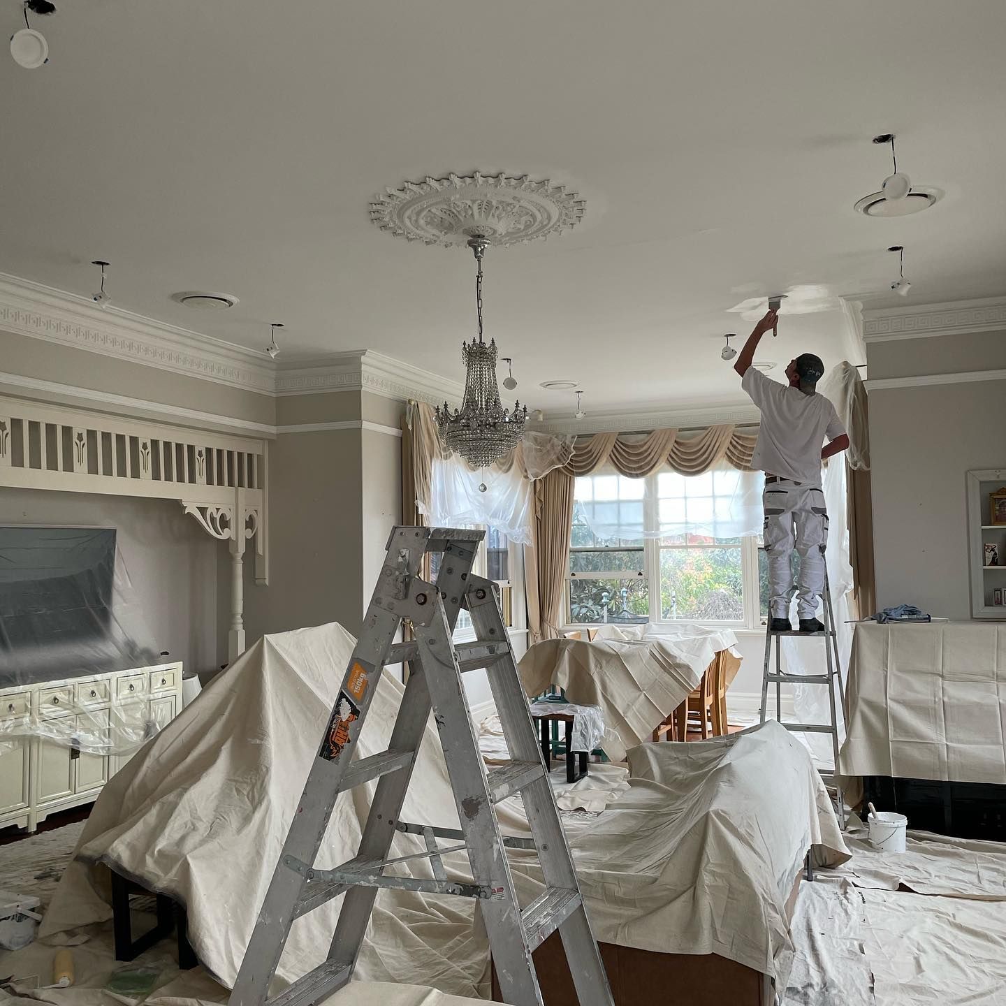 Painter painting interior of house