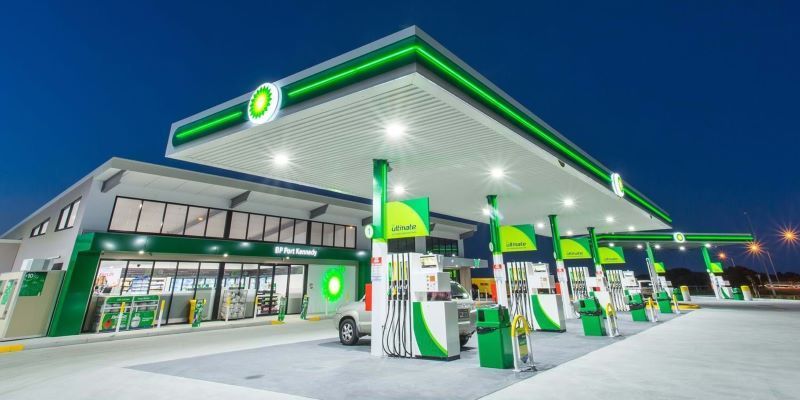 A bp gas station at night with a car parked in front of it - painting projects fremantle
