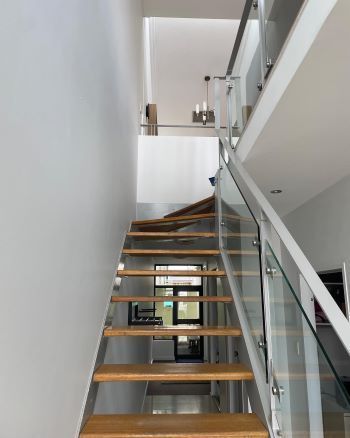 A staircase with wooden steps and a glass railing