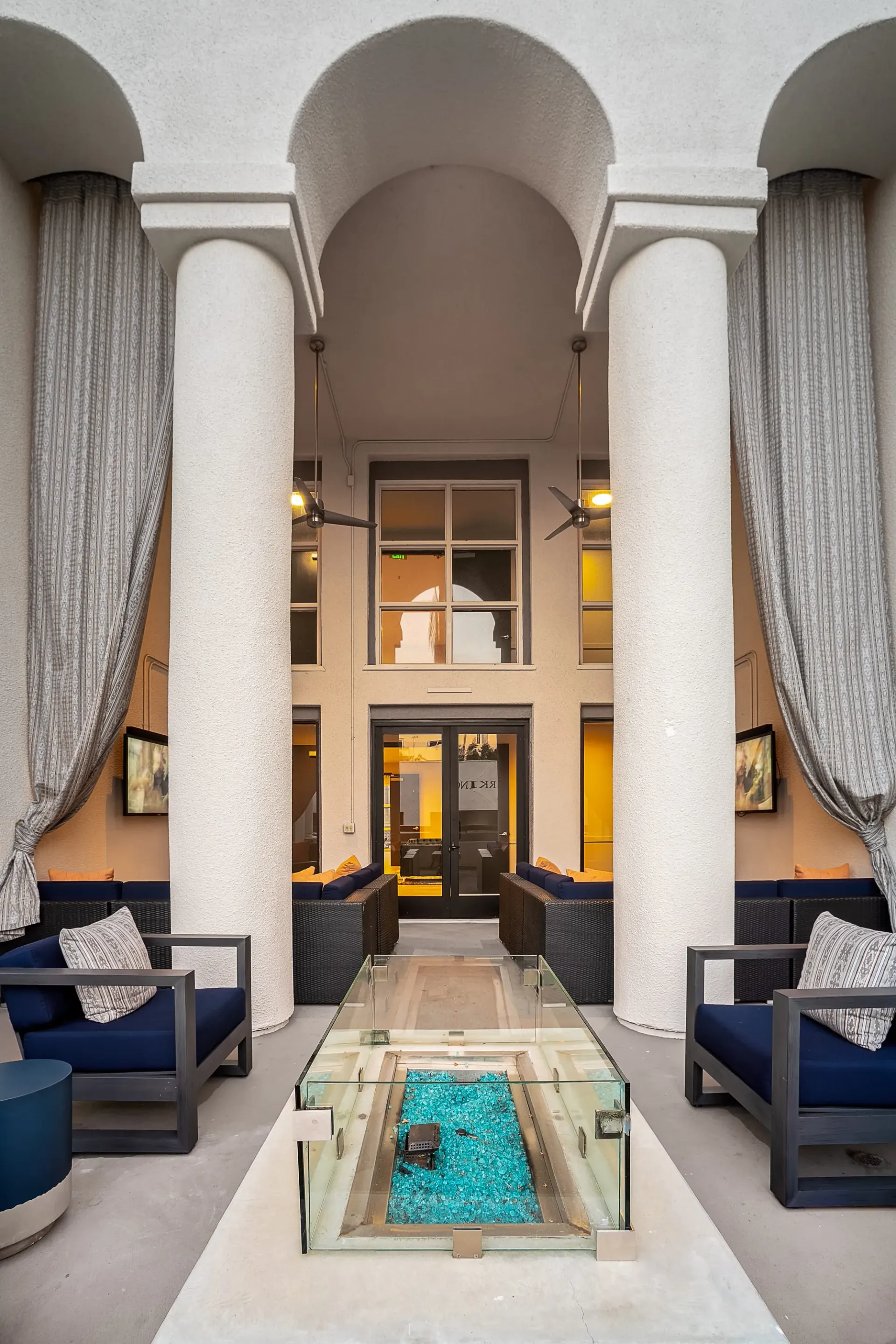 Outdoor lounge area with a modern fire pit and comfortable seating at The Preston in Los Angeles, CA.