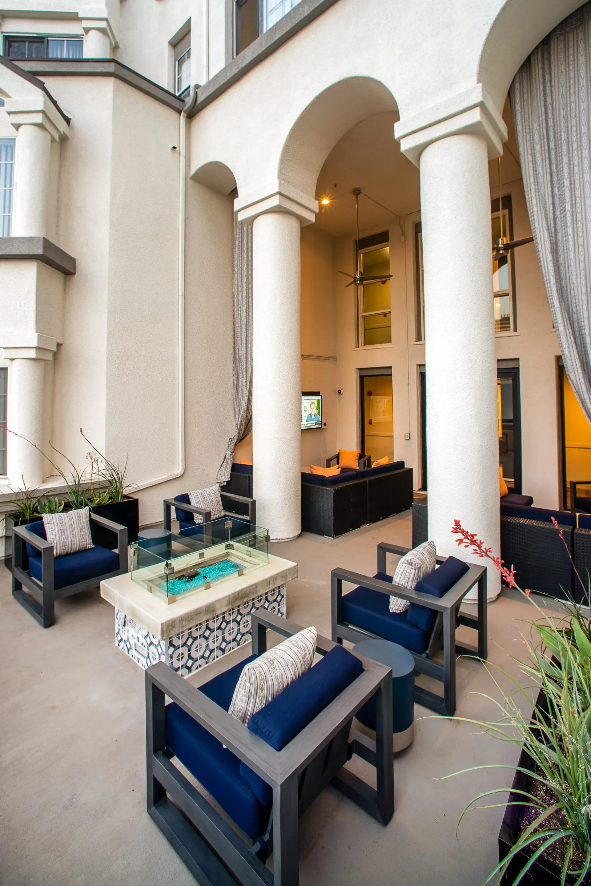 Outdoor seating area with a fire pit and couches at The Preston in Los Angeles, CA.