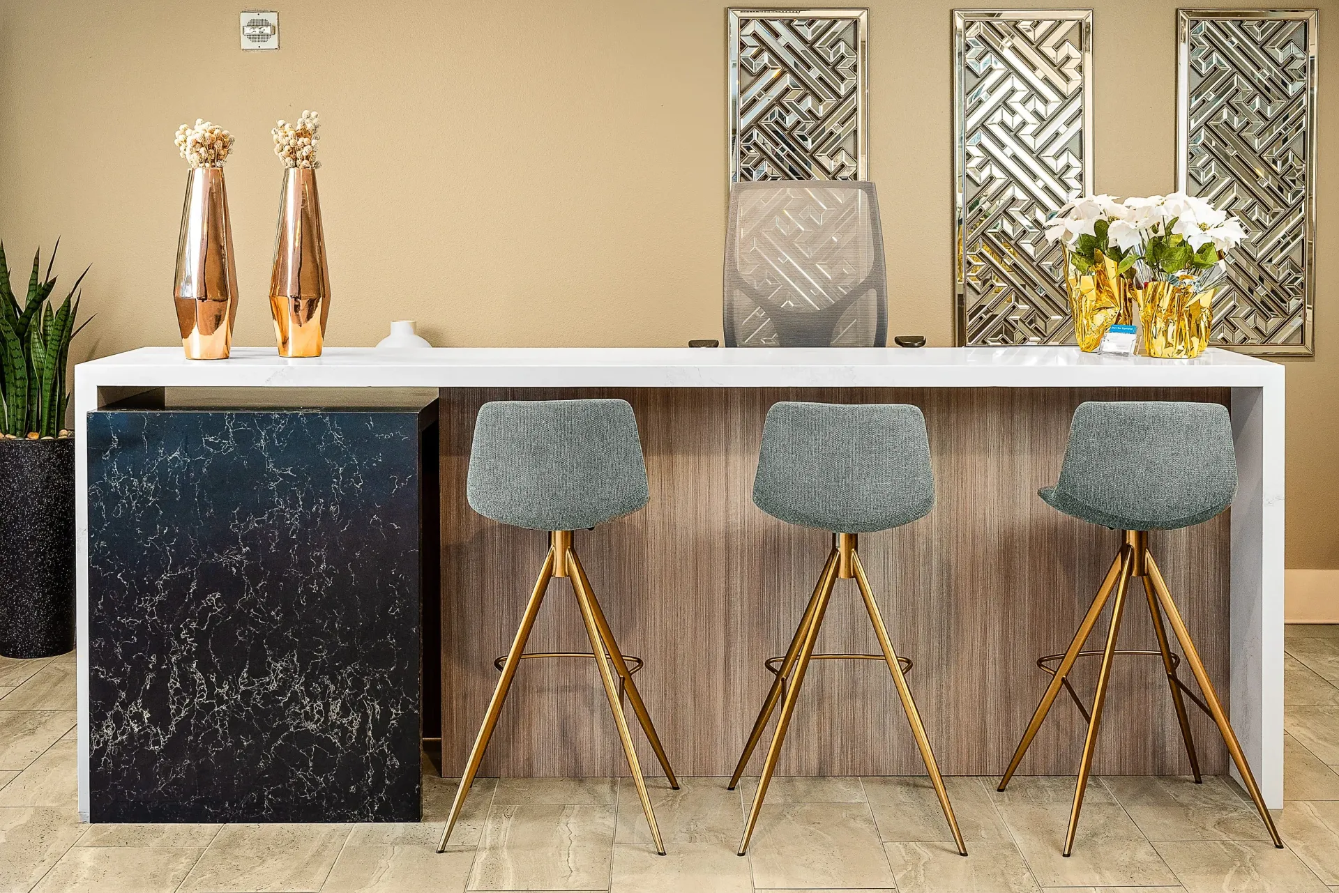 Modern reception desk with bar stools at The Preston in Los Angeles, CA.