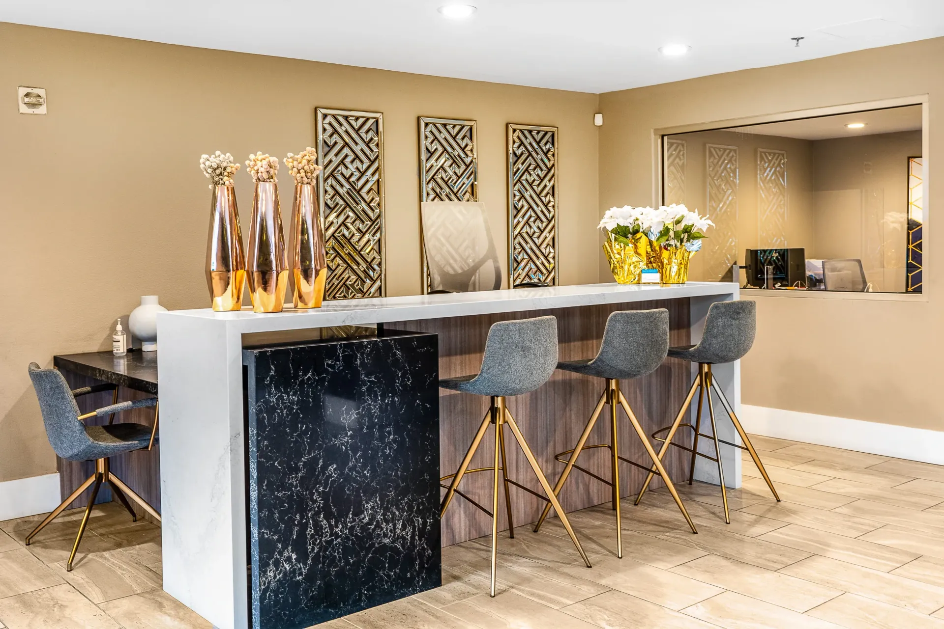 Bar area with seating and decorative vases at The Preston in Los Angeles, CA.