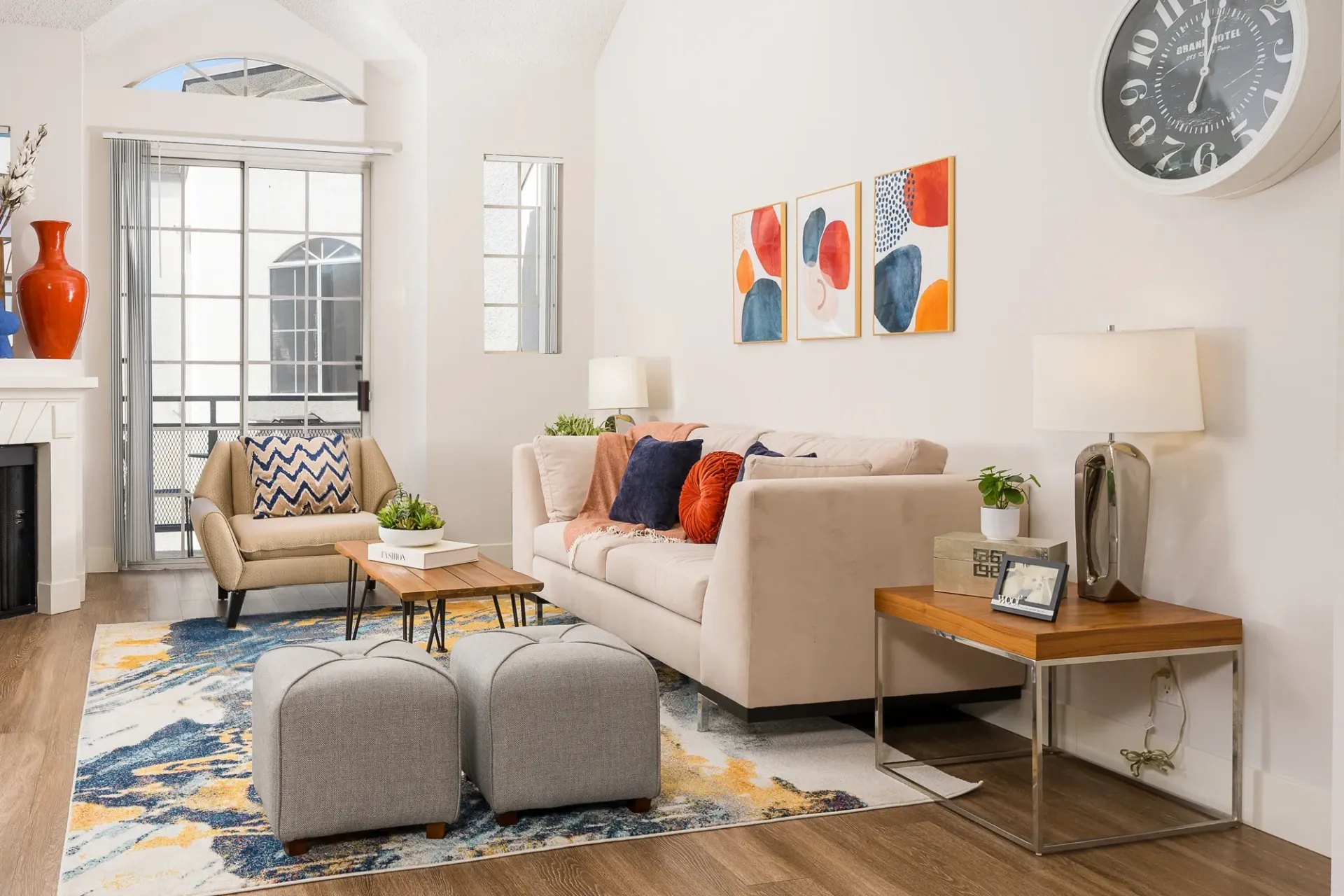 Living room with sofa, accent chairs, coffee table, and decorative items at The Preston in Los Angeles, CA.