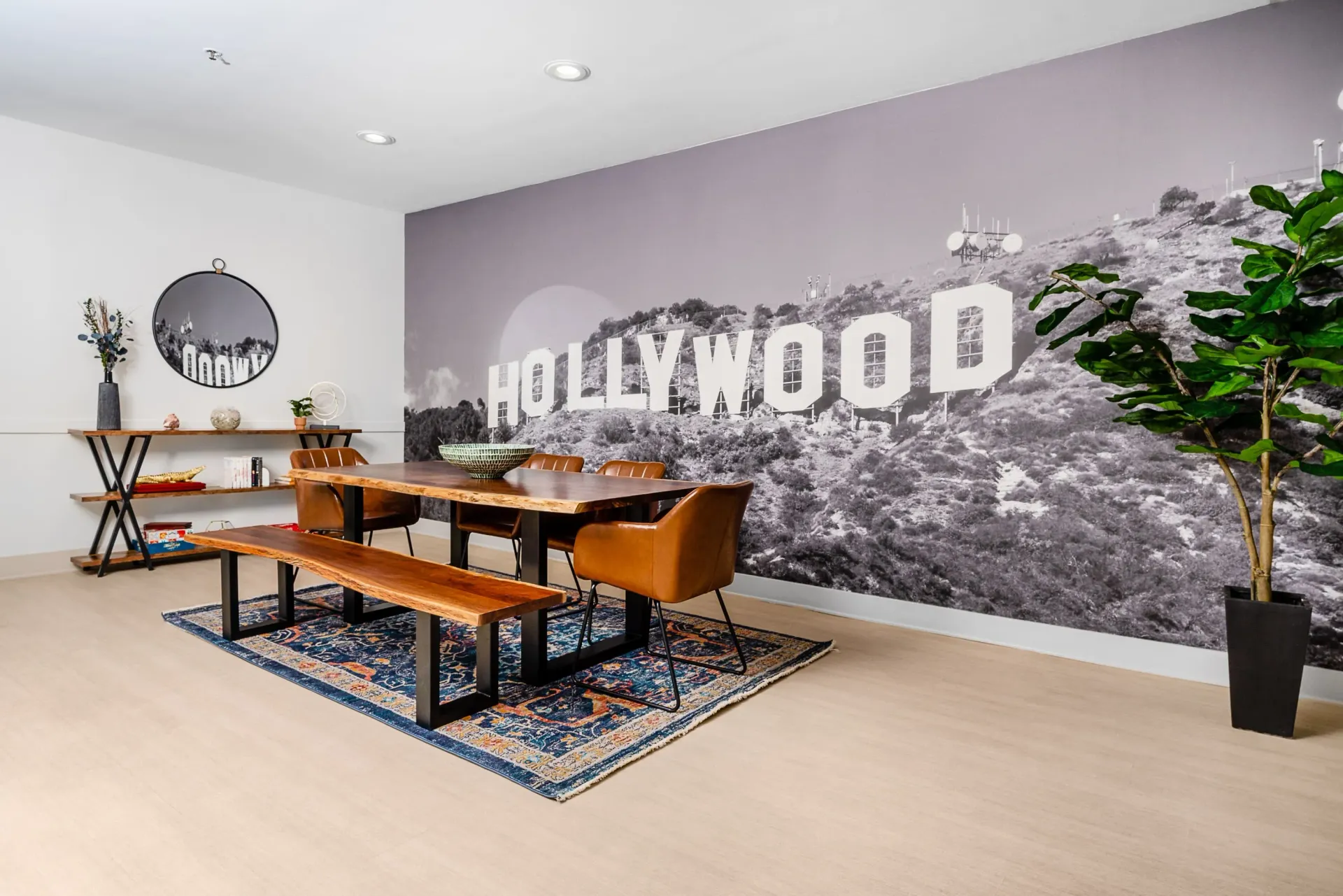 Dining area with a large mural of the Hollywood sign on the wall at The Preston in Los Angeles, CA.