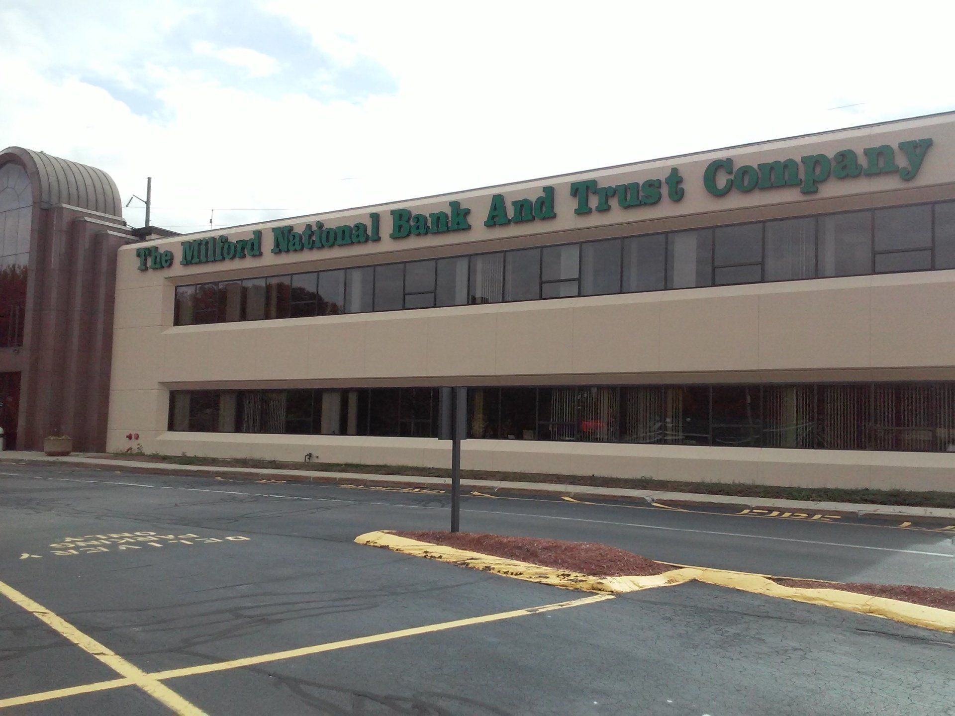 The Hilliard National Bank and Trust Company building with a tan facade and green lettering.