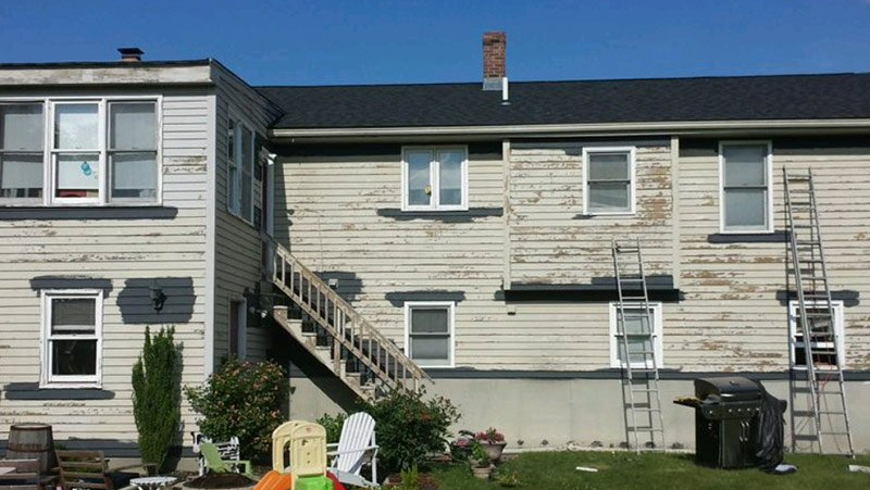 A house with a ladder on the side of it.