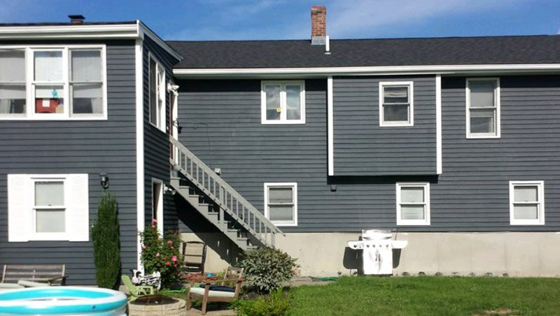 the back of a house with stairs leading up to it
