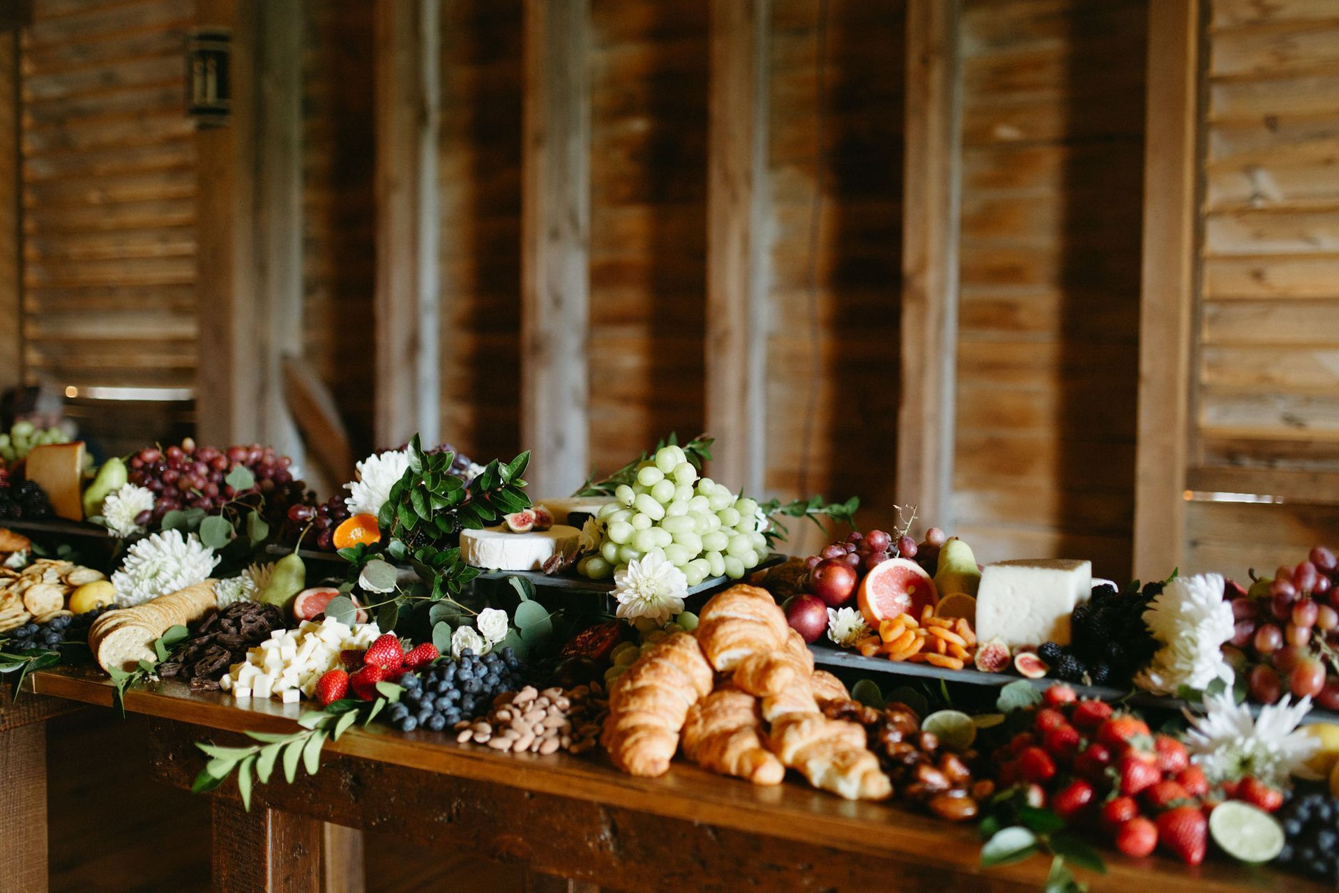 A wooden table topped with a variety of fruits and vegetables.