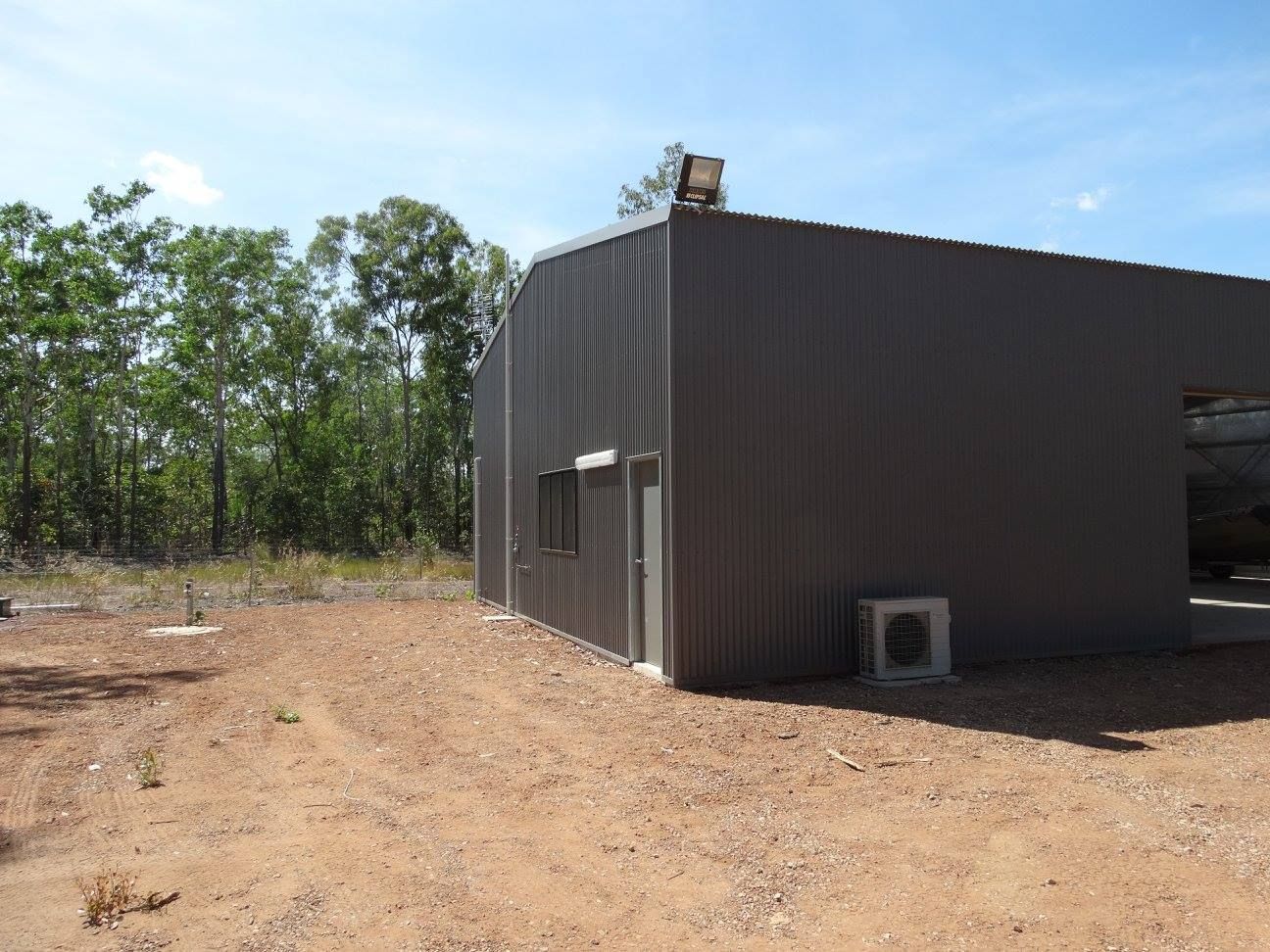 A Large Building With A Roof That Is Covered In Corrugated Metal — SLS Builders Pty Ltd in Humpty Doo, NT