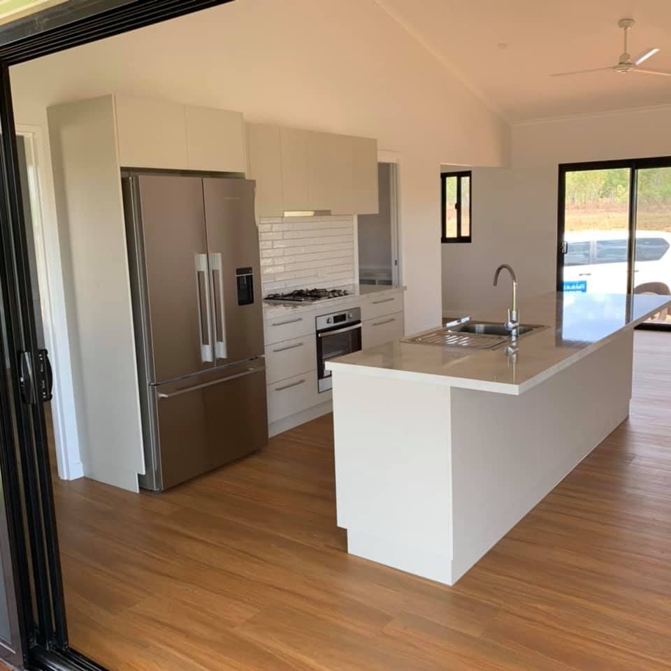 A Kitchen With Stainless Steel Appliances And A Large Island — SLS Builders Pty Ltd in Humpty Doo, NT