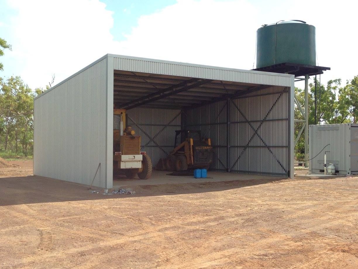 A Shed With A Water Tank And A Bulldozer Inside Of It — SLS Builders Pty Ltd in Kununurra, WA
